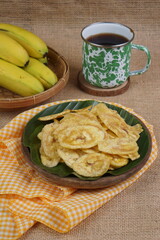 Indonesian banana chips on a wooden bowl with a traditional property theme photographed with studio light