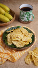 Indonesian banana chips on a wooden bowl with a traditional property theme photographed with studio light