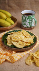 Indonesian banana chips on a wooden bowl with a traditional property theme photographed with studio light