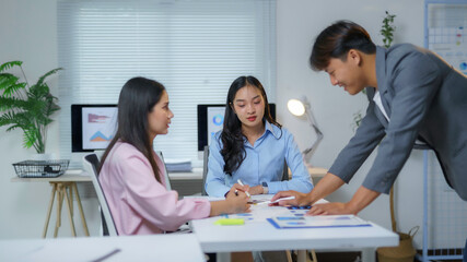 Business team analyzing financial charts and graphs, discussing strategies and planning for better business performance