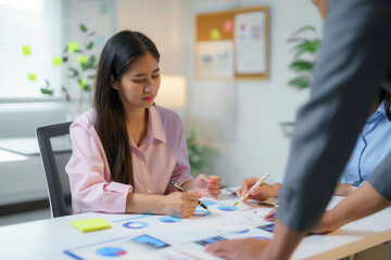 Businesspeople are working together, analyzing financial data and discussing growth strategies in a modern office environment