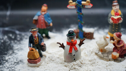 Christmas decorations, ointments, miniatures, trees, people with background of snow and rocks