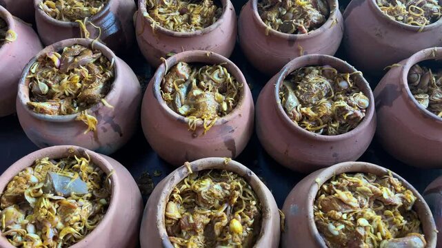 Handis filled with mutton and garnished with onions and spices.
