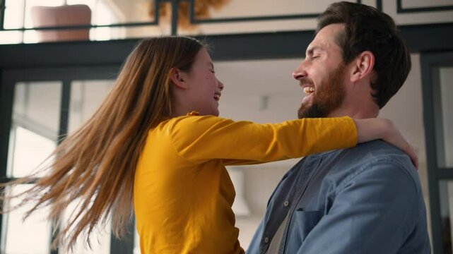 Carefree Caucasian family laugh guy man male dad parent holding swirling happy little girl kid daughter loving father daddy embrace spin child schoolgirl hug touching noses together childcare at home