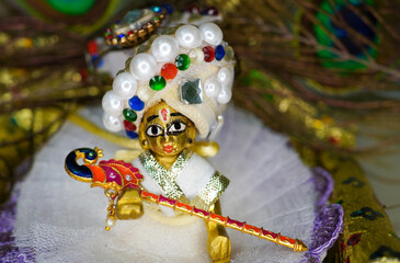Close up on statue of Hindu God Lord Krishna also known as Bal Gopal sitting on his throne on...