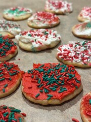 Festive Christmas cookies decorated by a child, with vibrant red and green sprinkles and icing. A fun holiday tradition for families with young kids.