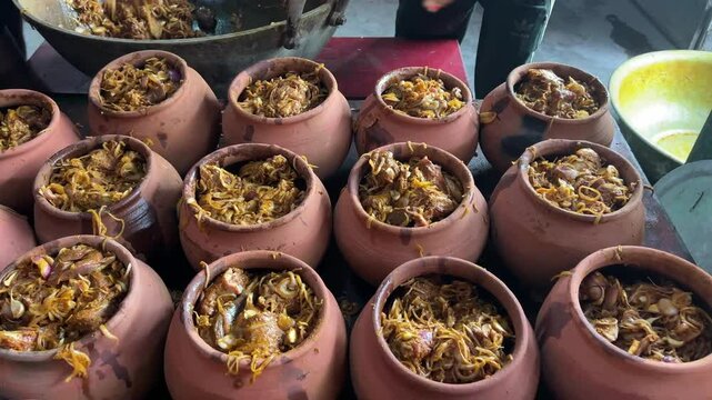 Handis filled with mutton and garnished with onions and spices.