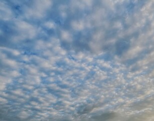 Beautiful sky with fluffy white clouds, soft and serene atmosphere, perfect for a clear and peaceful day