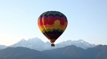 Fototapeta premium Colorful Hot Air Balloon Soaring Over Snowy Mountain Peaks