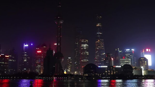 Shanghai Skyline at Night. Urban District, Huangpu River and skyscrappers. China. Illuminated cityscape. Waitan embankment.