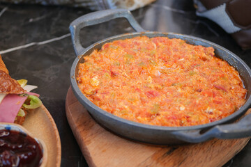 Turkish Menemen omelet in a frying pan. .