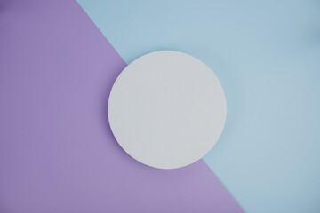 Top view of empty white cirle on blue and purple geometric background