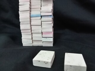 A stack of white and blue rubber eraser on a black background. eraser for kids in school
