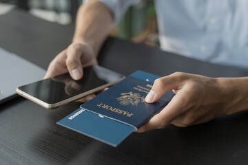 Hand Man Online booking and buying plane tickets using laptop phone and credit card Planning trip...