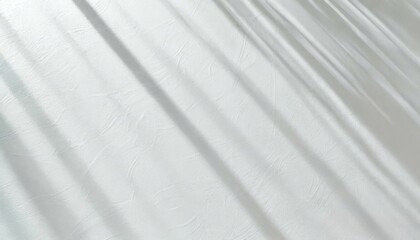 Obraz premium Soft light rays streaming across a smooth white surface, creating a serene and abstract background perfect for design, presentations, or creative projects