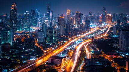 Fototapeta premium A vibrant city skyline at night with illuminated buildings and flowing traffic.