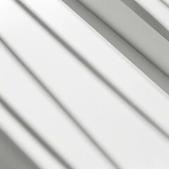 Obraz premium Soft light rays streaming across a smooth white surface, creating a serene and abstract background perfect for design, presentations, or creative projects. 