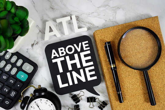 ATL - Above The Line acronym with calculator, alarm clock and magnifying glass, Business concept background