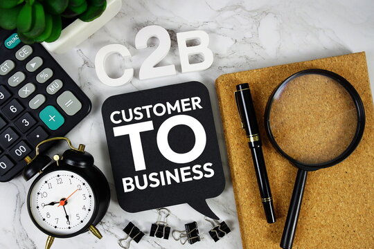 C2B - Consumer To Business acronym with calculator, alarm clock and magnifying glass, business concept background