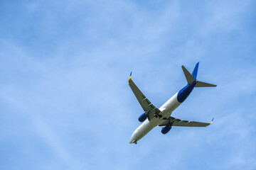 Airplane flying in the sky preparing to land at the airport. Air travel and traveling abroad