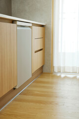 A minimalist interior in wood tones with warm sunlight streaming in.