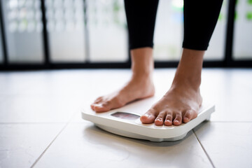 Lose weight. Fat diet and scale feet standing on electronic scales for weight control. Measurement...