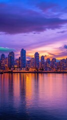 Fototapeta premium A vibrant city skyline at sunset reflecting on the water.