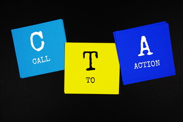 CTA - Call To Action acronym text on sticky note on black background