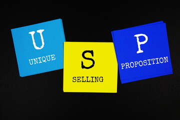 USP - Unique Selling Proposition acronym text on sticky note on black background
