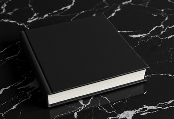 Black book cover mockup design, Hardcover book mock up on black marble background