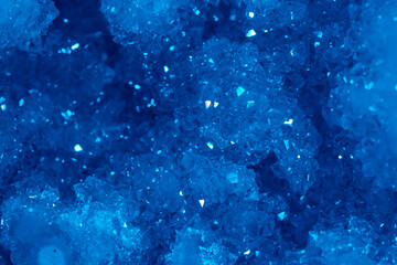 Blue Crystal Mineral Stone. Gems. Mineral crystals in the natural environment. Texture of precious and semiprecious stones. Seamless background with copy space colored shiny surface of precious stones