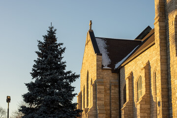 A brick church and tree in the sunshine