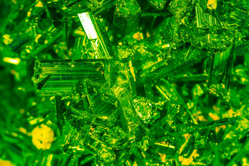 Green crystal mineral stone. Gems. Mineral crystals in the natural environment. Texture of precious and semiprecious stones. Seamless background with copy space colored shiny surface of precious stone