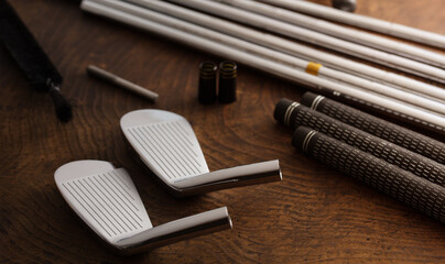 Golf club making. Golf club components on a work desk or work bench. grips, shaft, ferrules and,...
