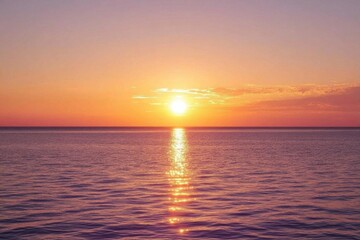 Naklejka premium Serene sunset over calm ocean waters, creating a peaceful atmosphere.