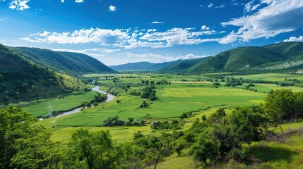 Fototapeta premium High-end photography of a picturesque valley with a river and lush green fields under a blue sky