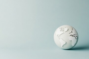 Minimalist globe on a soft blue background.