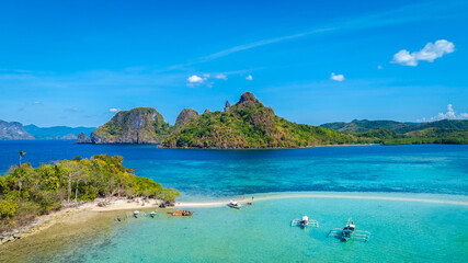 Aerail view of  tropical exotic island sand bar separating sea in two with turquoise  in El Nido, Palawan, Philippines.