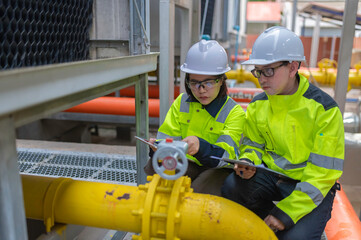 Maintenance technician at a heating plant,Petrochemical workers supervise the operation of gas and oil pipelines in the factory,Engineers put hearing protector At room with many pipes