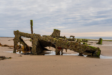 Naklejka premium Stones on the beach and the ST Pasages Shipwreck between Ballasalla and Sartfield, Isle of Man