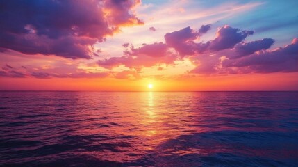 Obraz premium A serene sunset over calm ocean waters, showcasing vibrant colors.