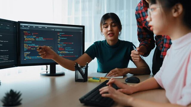 Slow motion back end software developer engineer for computer programming working together on debugging writing computing code, solving complex algorithms display on monitor in office. Burgeoning