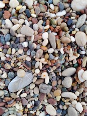 Naklejka premium A Vibrant Collection of Pebbles: Diversity and Harmony in Nature's Smallest Forms, a Metaphor for Unity and Uniqueness.