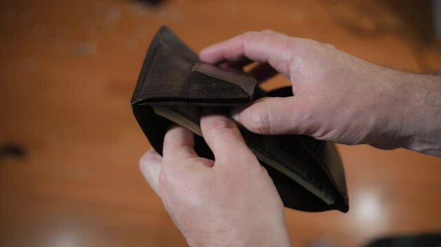 Man opens black wallet with money. Close shot