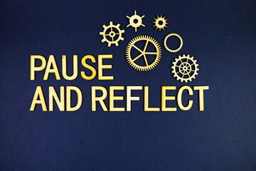 Pause and Reflect alphabet letters with gears element on navy blue background
