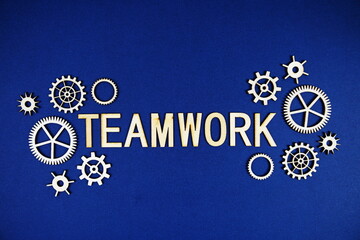 Teamwork alphabet letters with gears element on navy blue background