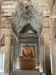 View of headless Buddha statue in Ta Prohm temple, Siem Reap, Cambodia