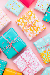 Obraz premium Colorful gift boxes arranged on pink background create festive atmosphere. vibrant patterns and cheerful colors evoke feelings of joy and celebration, perfect for any occasion