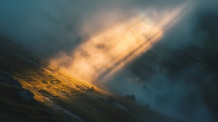 Obraz premium Dramatic light breaking through fog mountain landscape photography natural setting aerial view nature's beauty