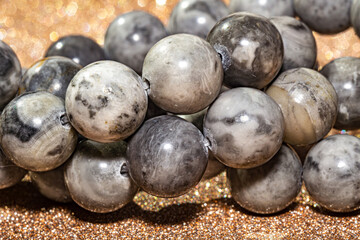 Beautiful round beads of gray jasper in macro photography, perfect for crafting and jewelry design. Decorative round stone beads of gray color  for boho jewelry design.